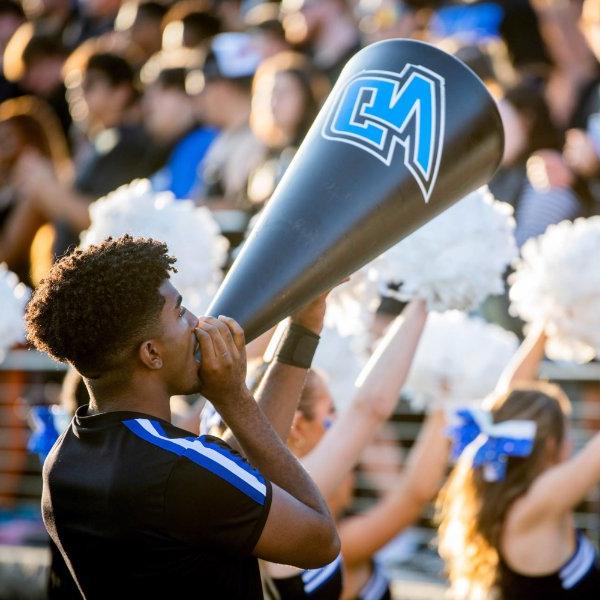 GVSU cheerleader yells into megaphone during Lakers football game